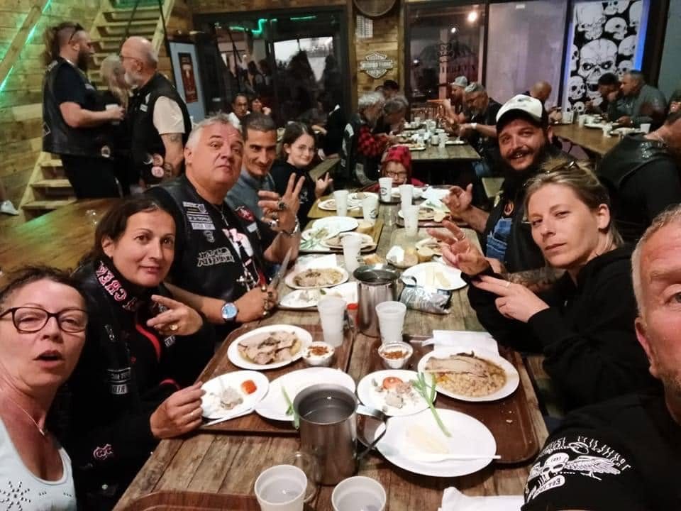 Bikeuses et bikers autour d'un repas d'étape