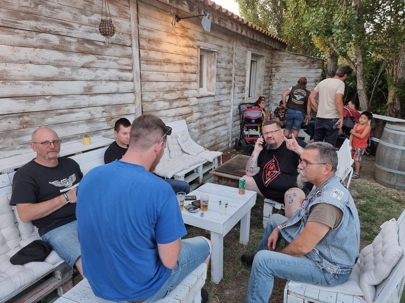 Bikers réunis en terrasse devant un bâtiment en bois